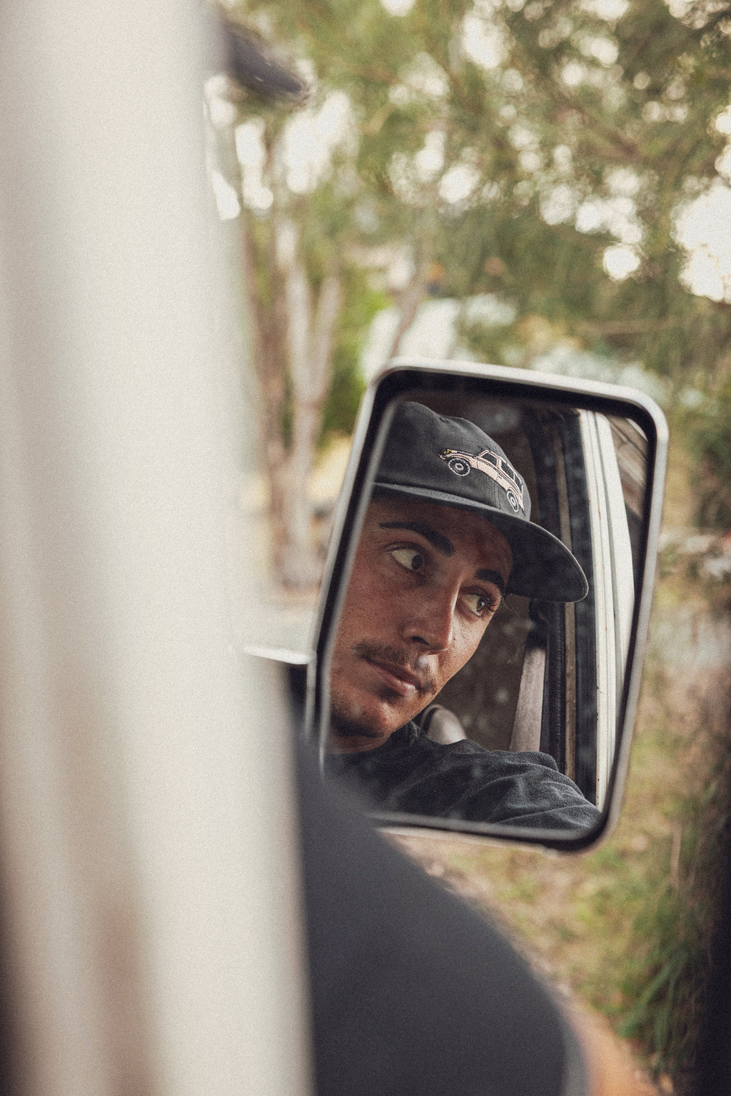 Person wearing a black landcruiser troopy cap